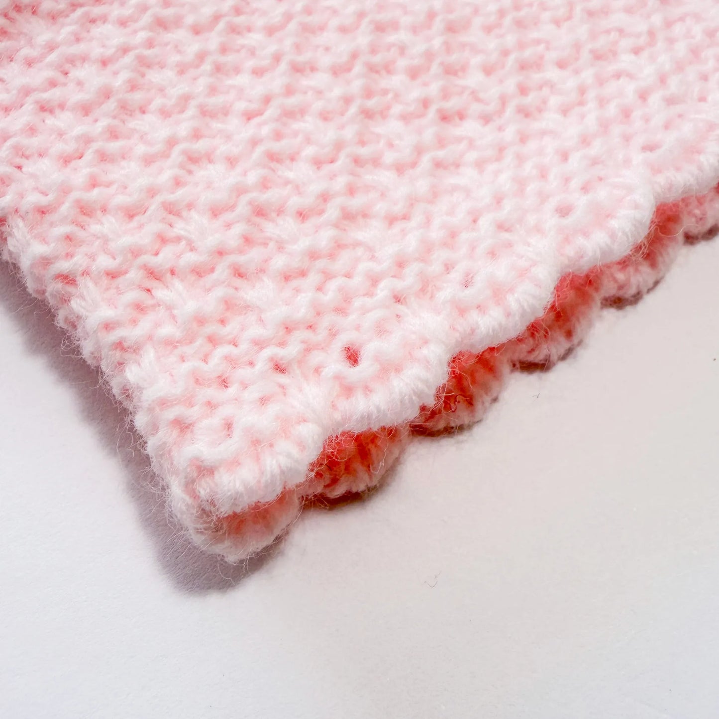 Detalle de conjunto de ni�a de peto con lazo, camiseta y gorro con pomp�n en tricot rosa