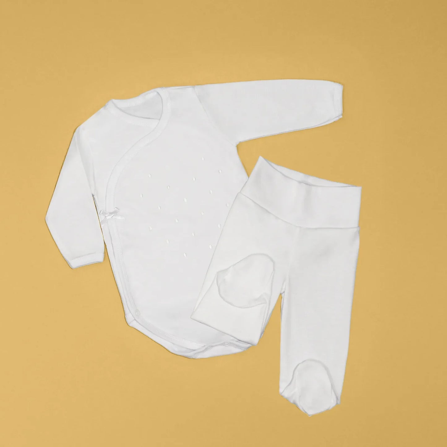 Body cruzado con pantalones com pies con bordado de lunares blanco