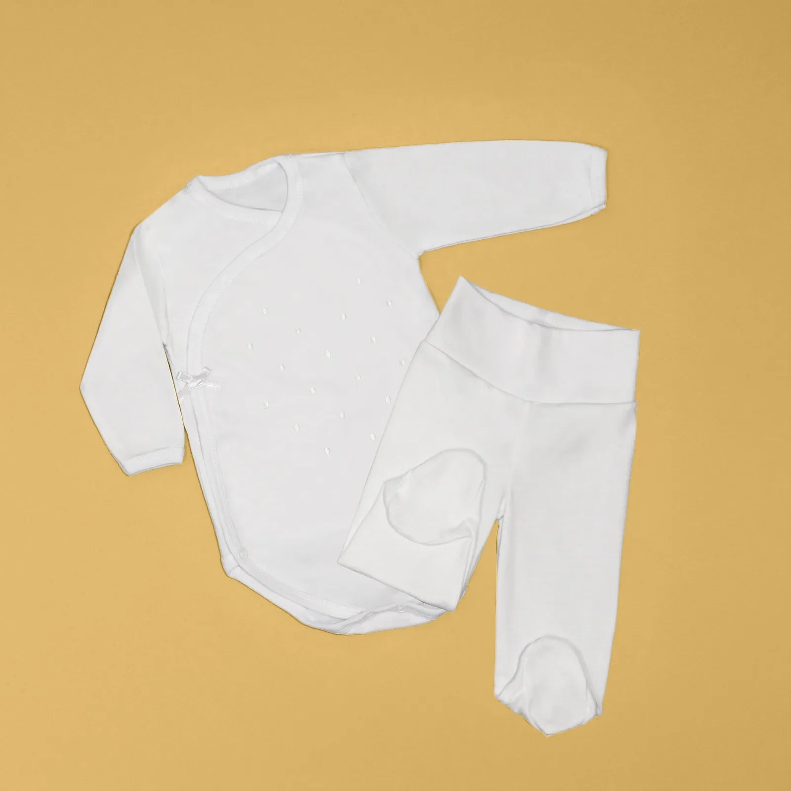 Body cruzado con pantalones com pies con bordado de lunares blanco