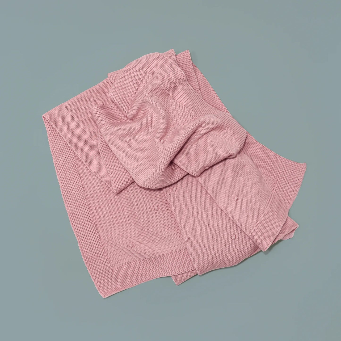 Manta de punto con relieve de pompones rosa