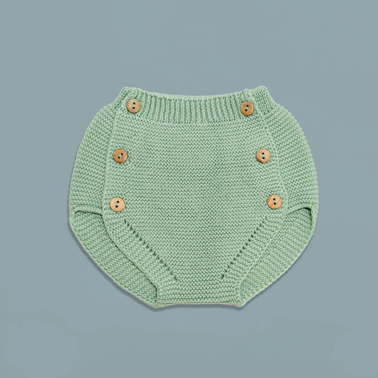 Cubrepañal de punto con botones de madera verde